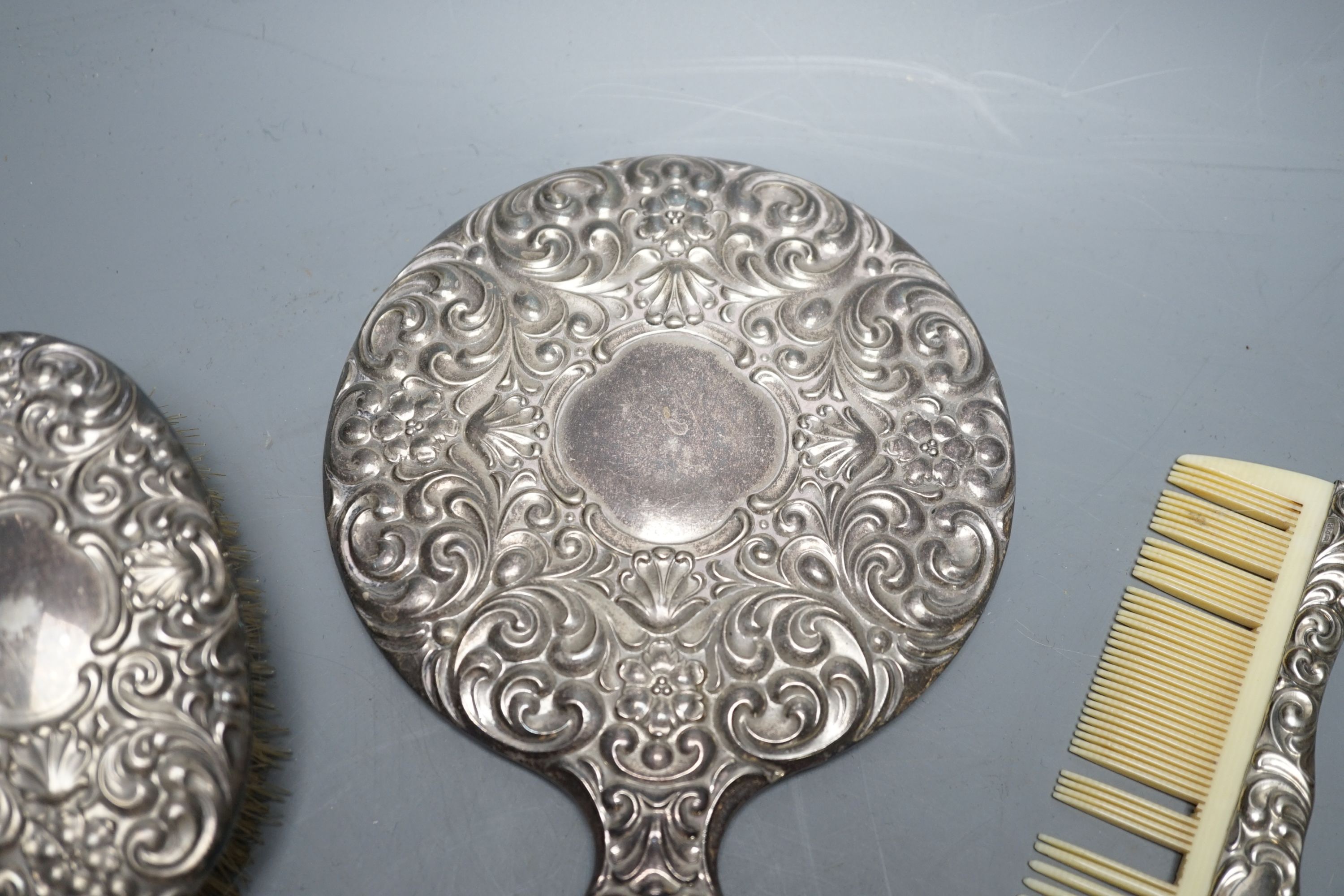 A continental 800 standard white metal mounted four piece mirror and brush set.